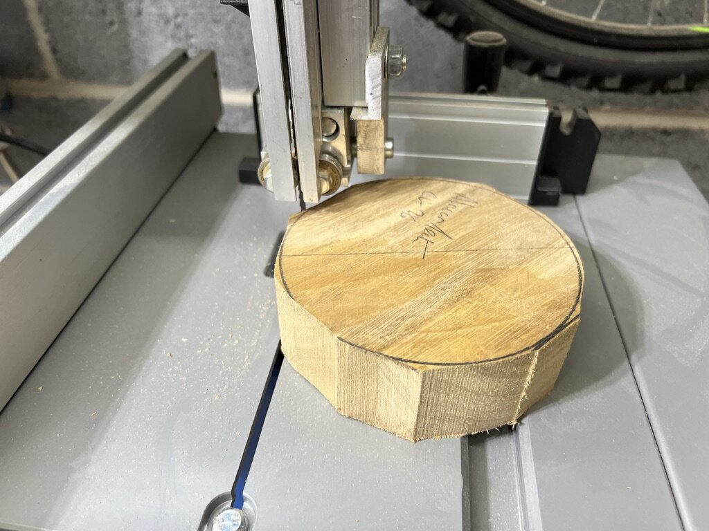The corners being cut from the African teak blank on the bandsaw