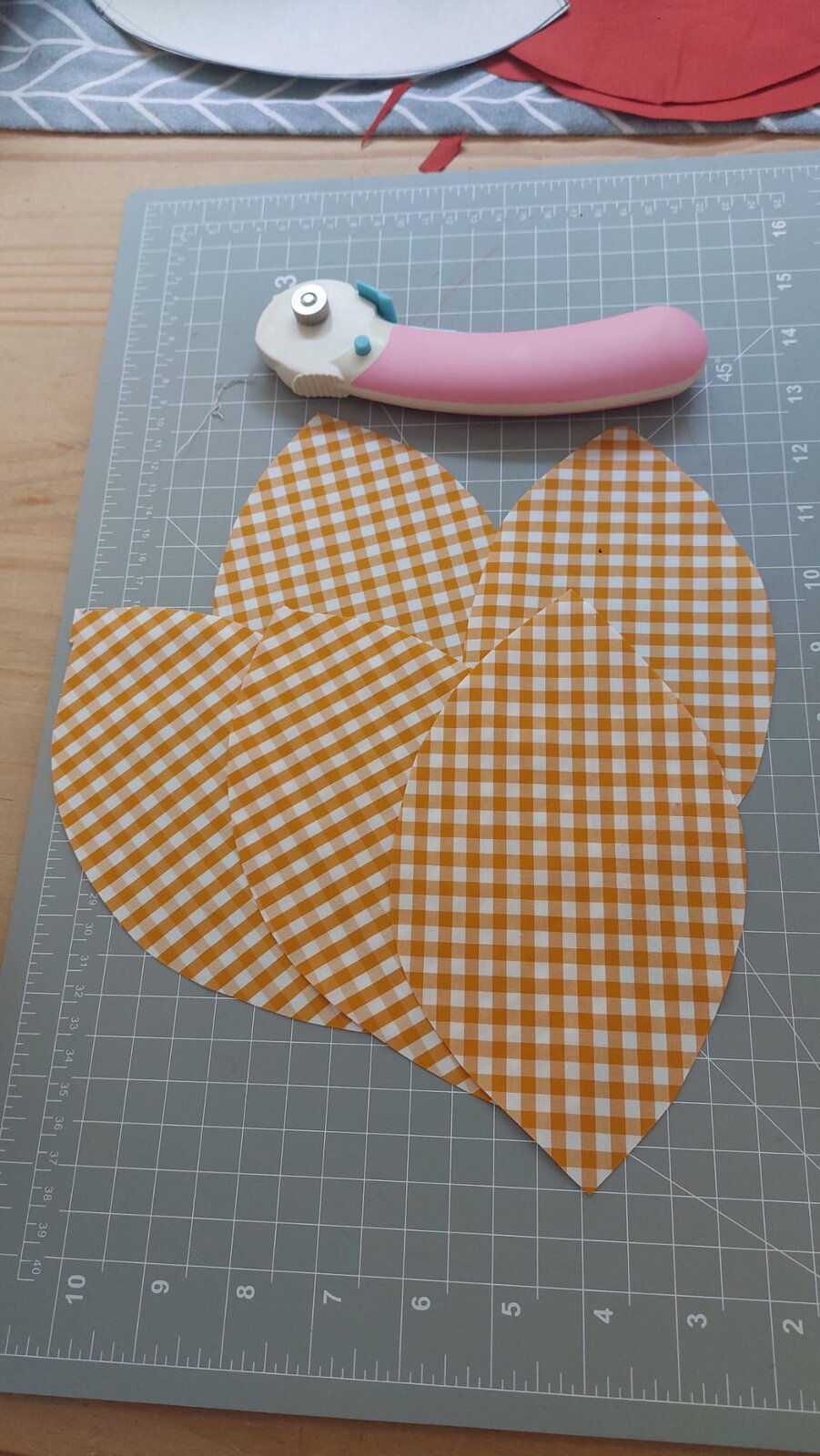 Oval pieces cut from orange gingham fabric